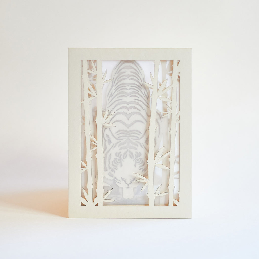 Elegant tiger drinking water among bamboo in forest