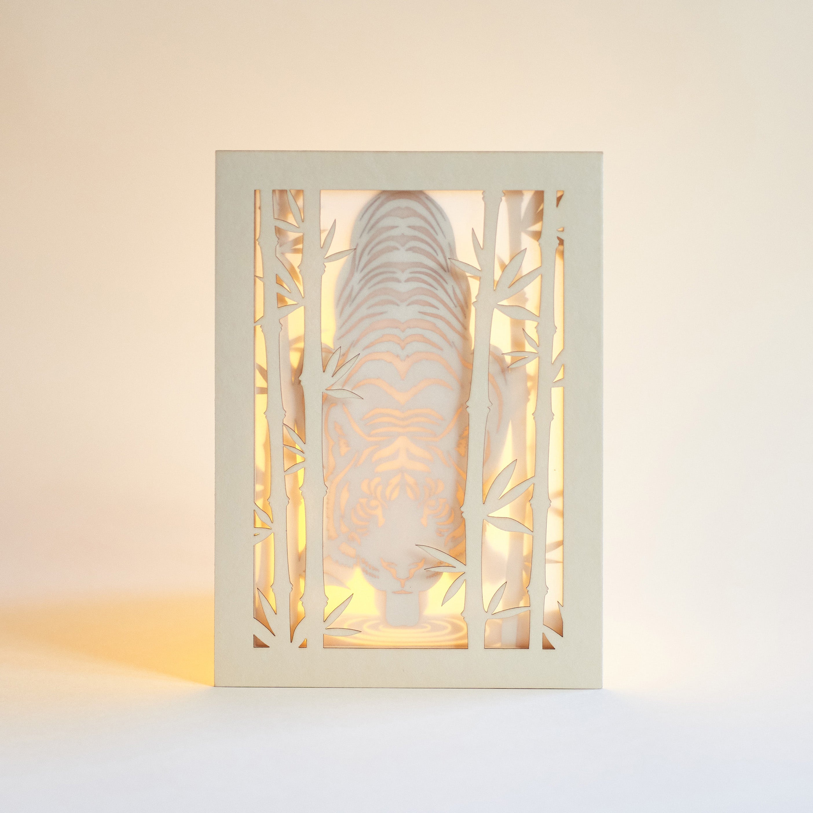 Elegant tiger drinking water among bamboo in forest