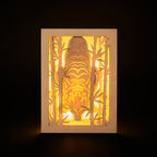 Elegant tiger drinking water among bamboo in forest