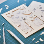 Burning candle with butterflies and moths drawn to flame