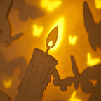 Burning candle with butterflies and moths drawn to flame
