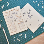 Burning candle with butterflies and moths drawn to flame