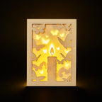 Burning candle with butterflies and moths drawn to flame