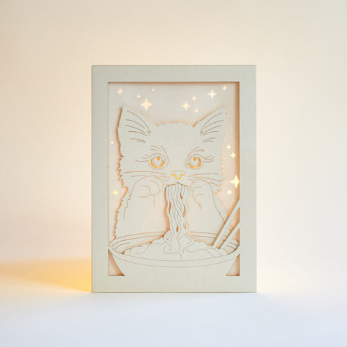 Adorable cat eating ramen noodles with chopsticks