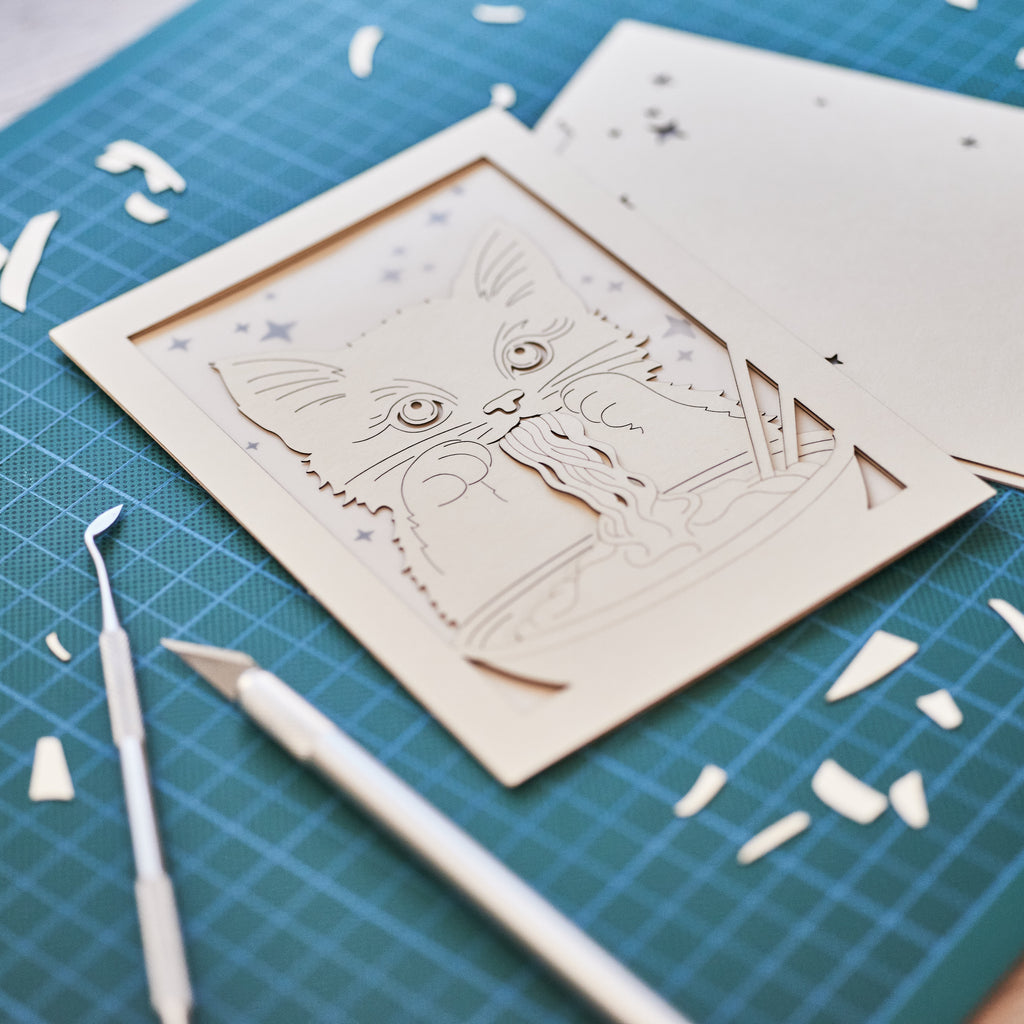 Adorable cat eating ramen noodles with chopsticks