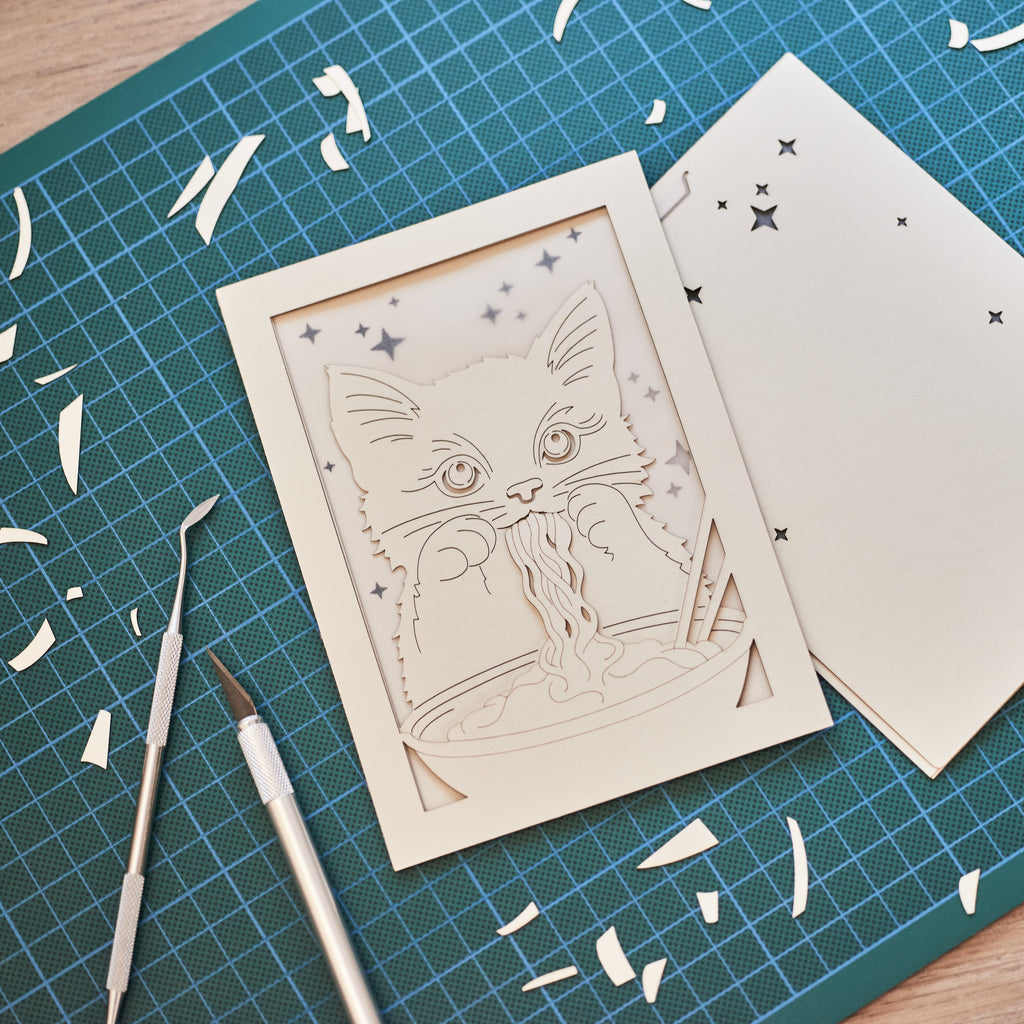 Adorable cat eating ramen noodles with chopsticks