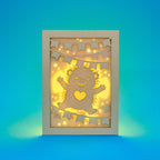 Cute hedgehog making snow angel with festive banner flags