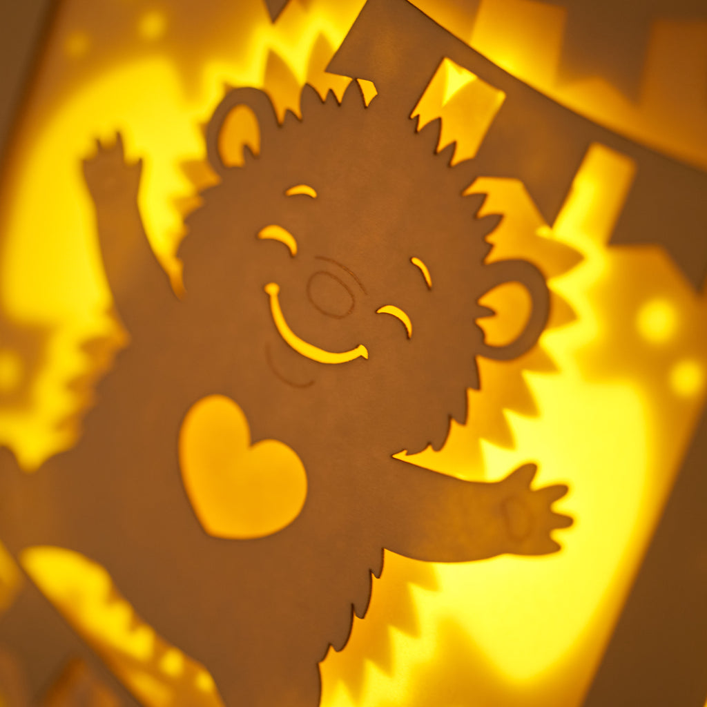 Cute hedgehog making snow angel with festive banner flags