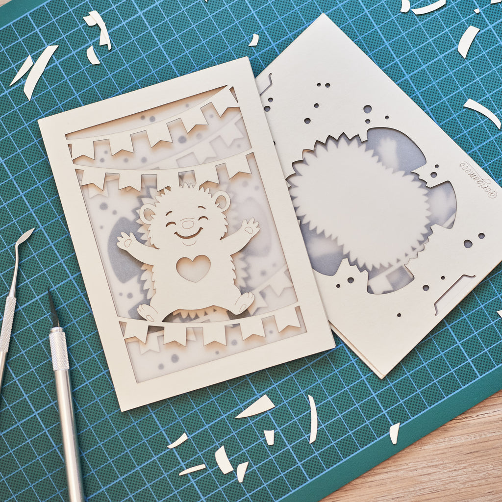 Cute hedgehog making snow angel with festive banner flags