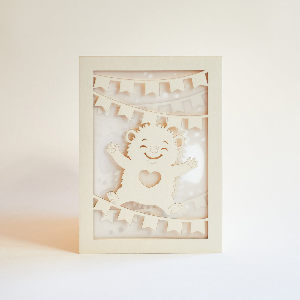 Cute hedgehog making snow angel with festive banner flags