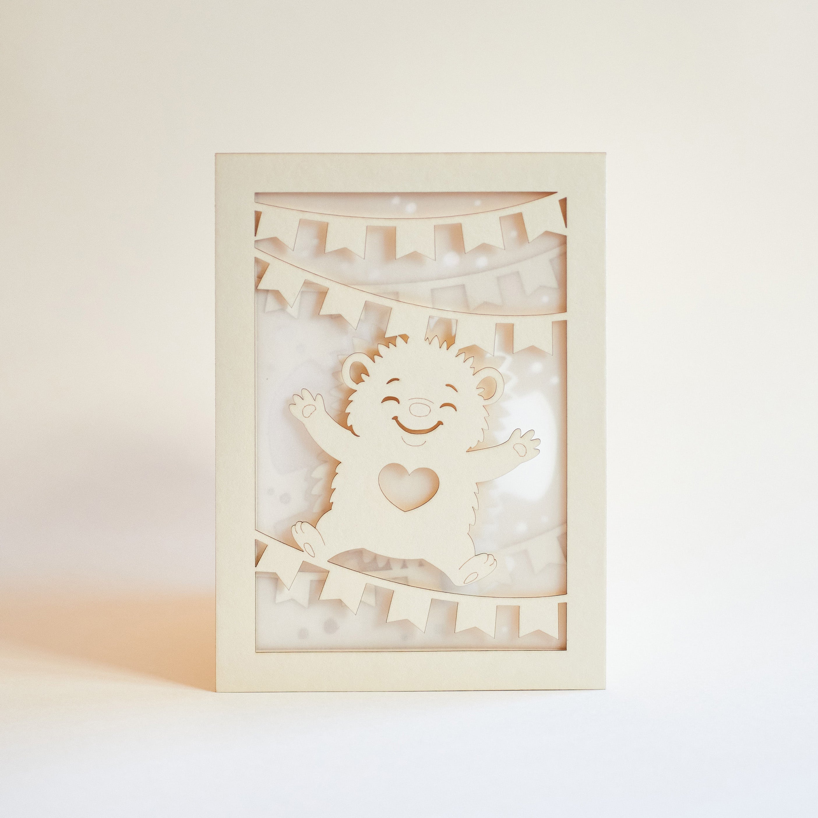 Cute hedgehog making snow angel with festive banner flags