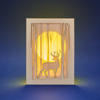 Graceful deer silhouette in winter forest with moon