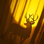 Graceful deer silhouette in winter forest with moon