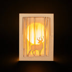 Graceful deer silhouette in winter forest with moon