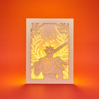 Zagreus from Hades game with sword standing in front of olive branches and flames