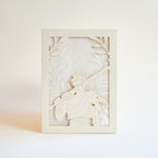 Zagreus from Hades game with sword standing in front of olive branches and flames