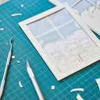 Cats basking on sunny windowsill with closed eyes and tails up