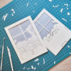 Cats basking on sunny windowsill with closed eyes and tails up