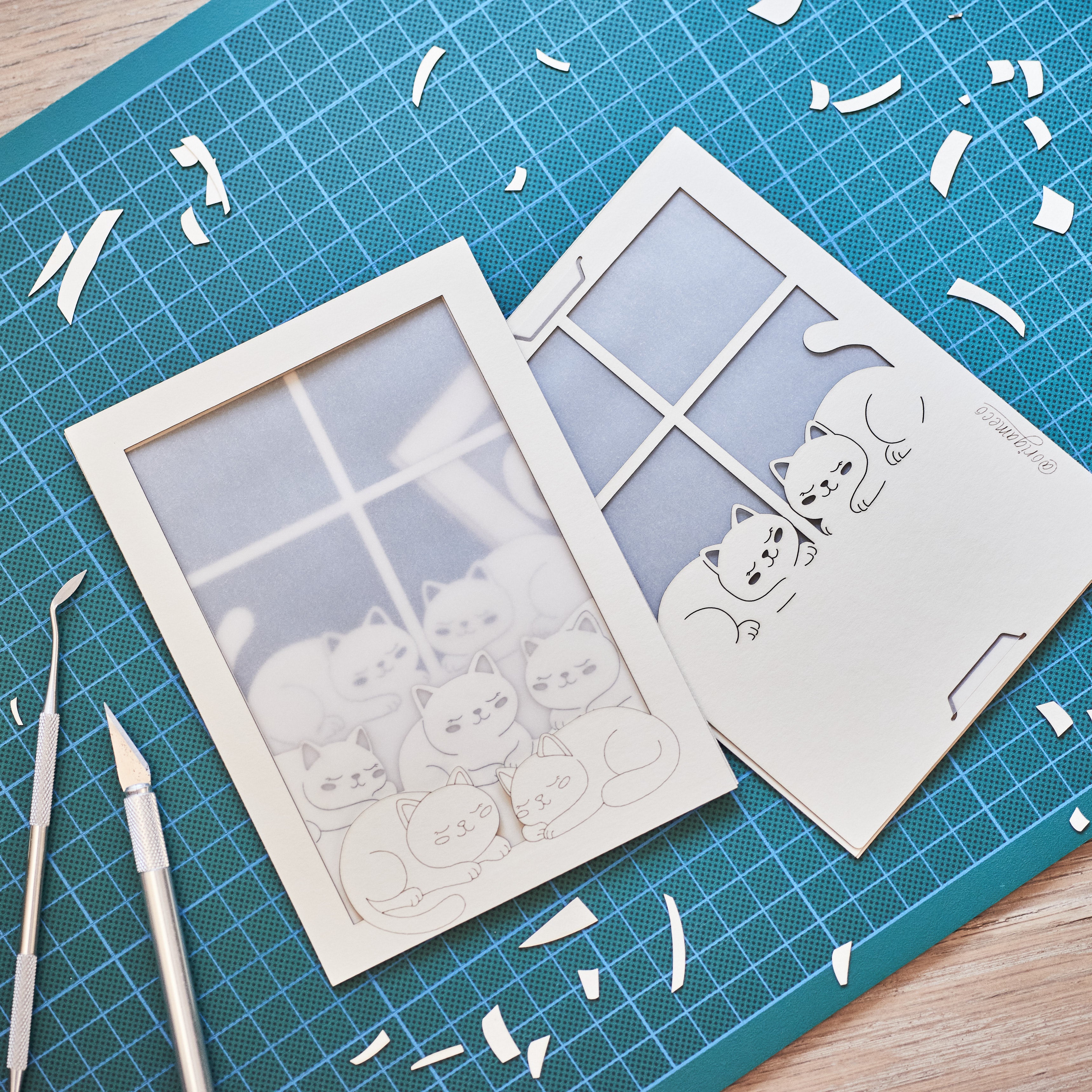 Cats basking on sunny windowsill with closed eyes and tails up
