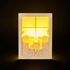 Cats basking on sunny windowsill with closed eyes and tails up