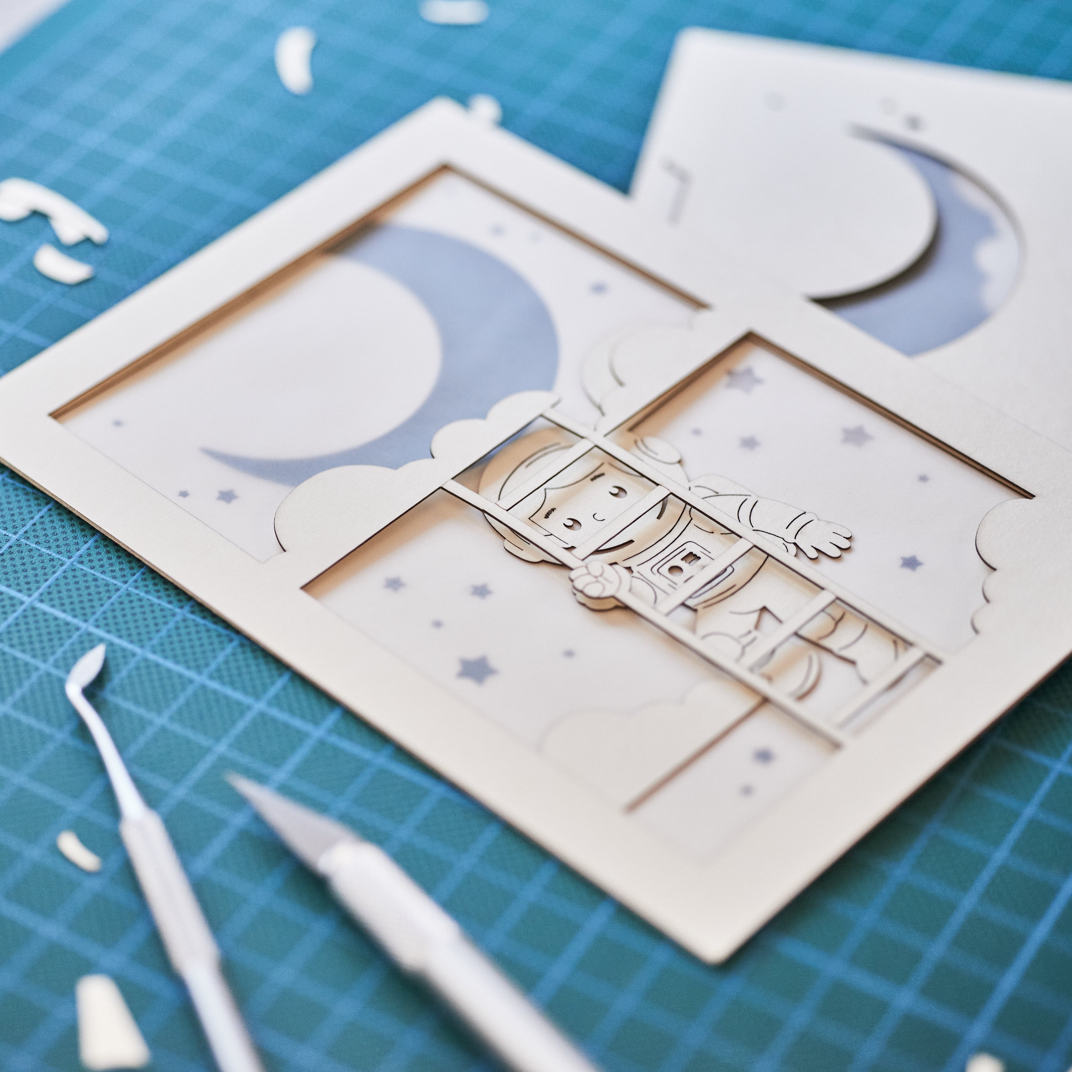 Little boy astronaut climbing ladder to moon and stars