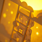 Little boy astronaut climbing ladder to moon and stars