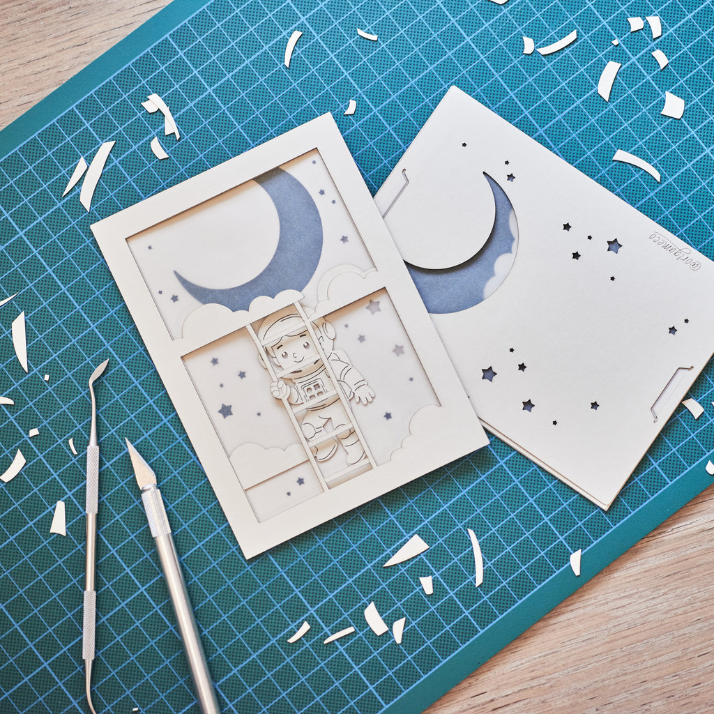 Little boy astronaut climbing ladder to moon and stars