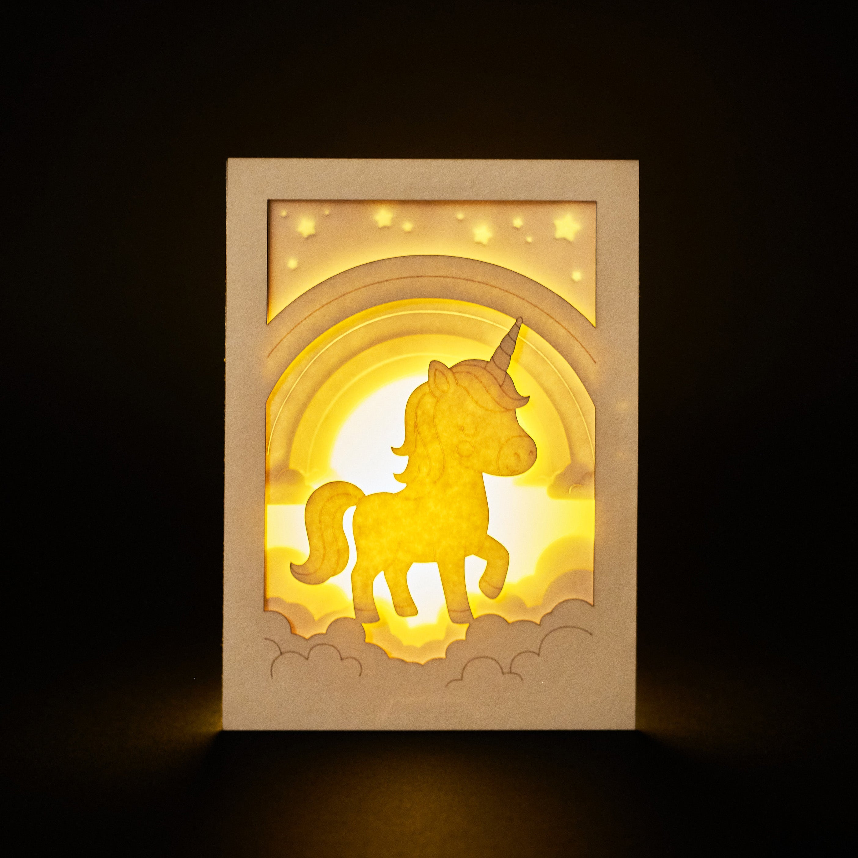 Chubby unicorn dancing under rainbow in clouds with stars