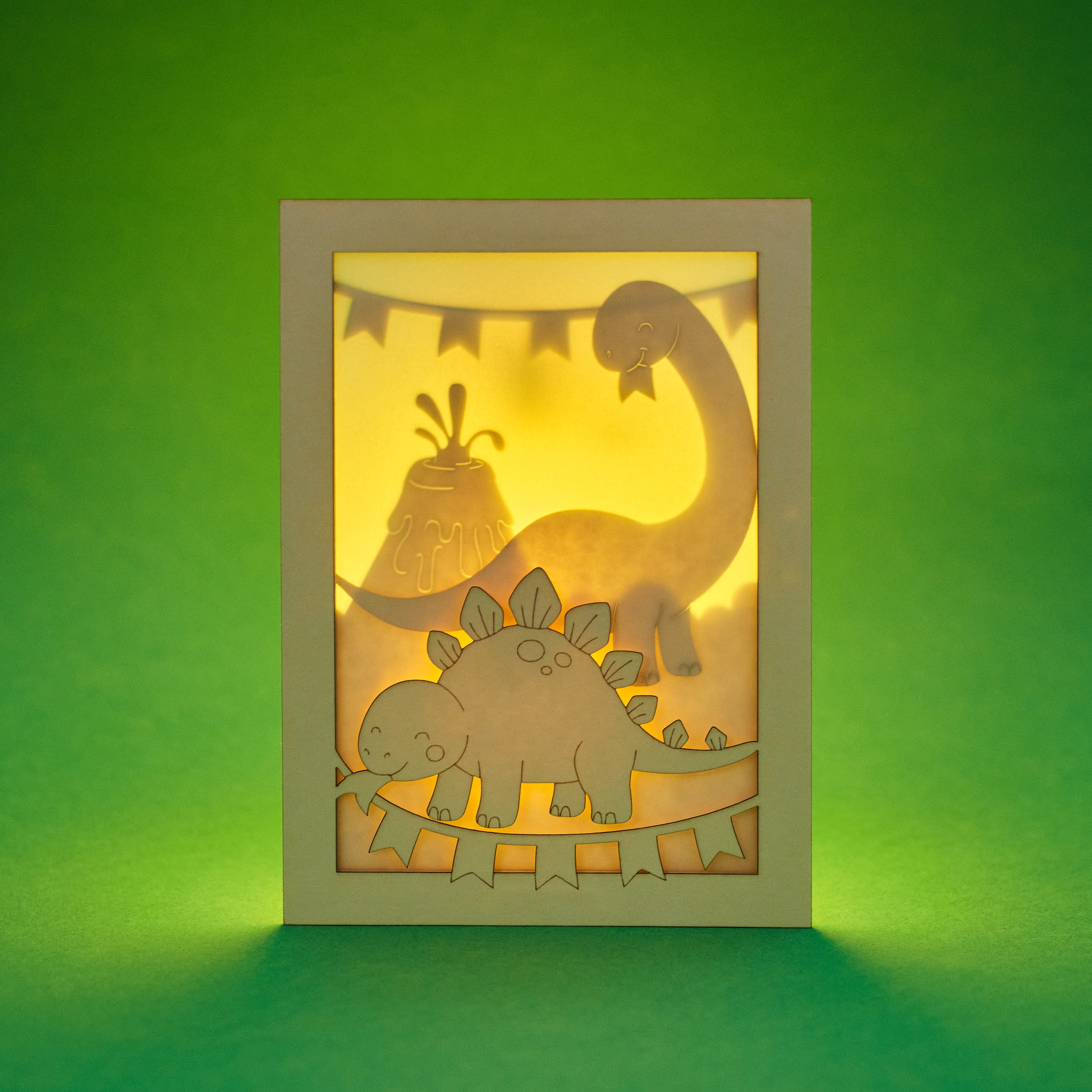 Adorable dinosaurs diplodocus and stegosaurus with birthday streamers and volcano