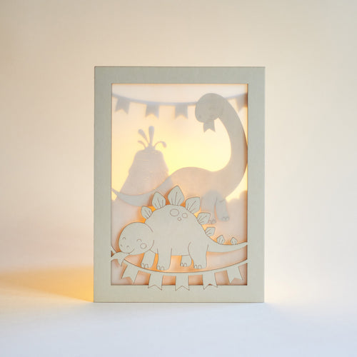 Adorable dinosaurs diplodocus and stegosaurus with birthday streamers and volcano