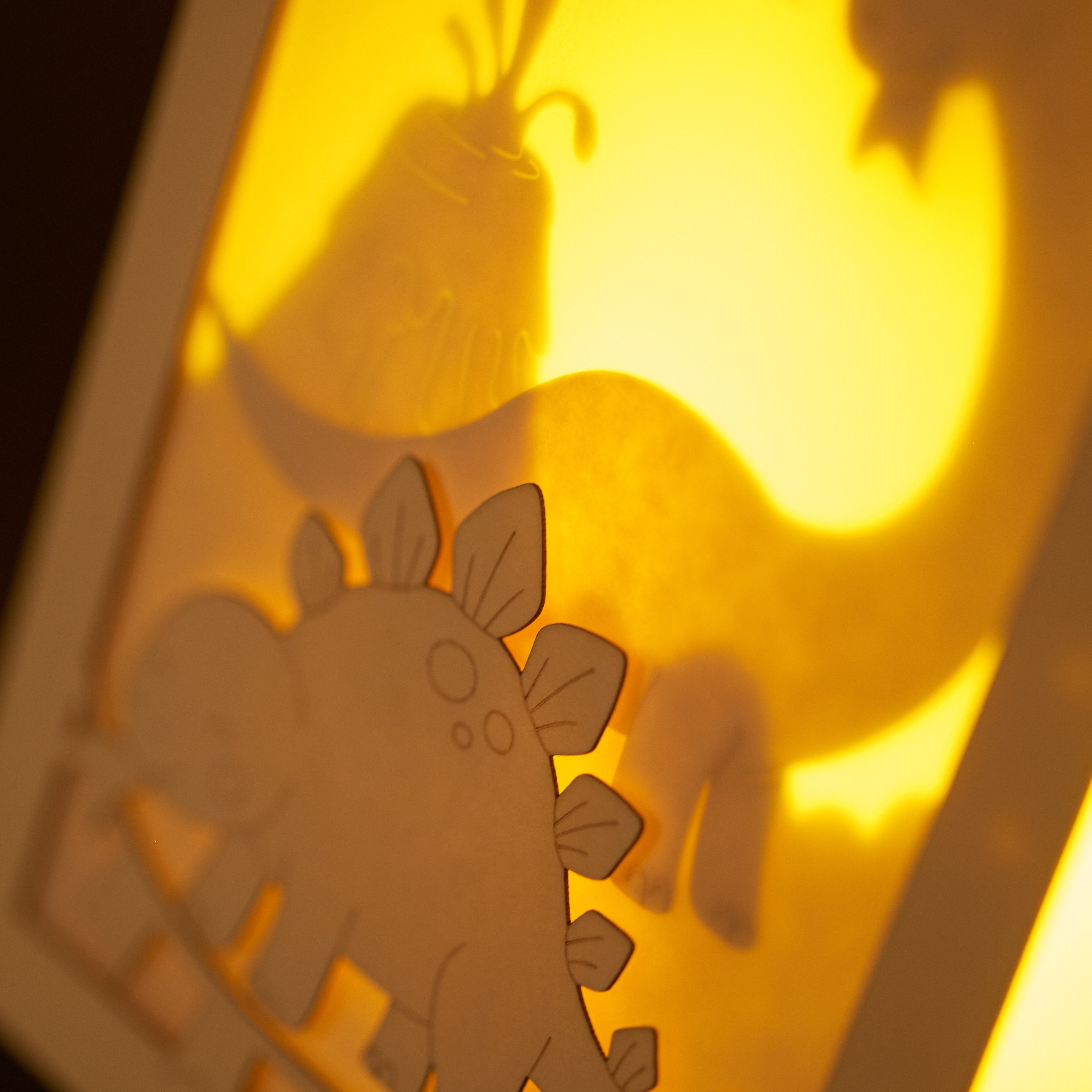 Adorable dinosaurs diplodocus and stegosaurus with birthday streamers and volcano