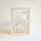 Adorable dinosaurs diplodocus and stegosaurus with birthday streamers and volcano