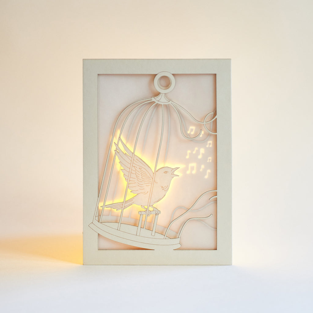 Bird escaping golden cage through song with broken bars