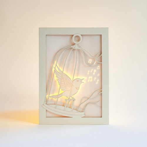 Bird escaping golden cage through song with broken bars