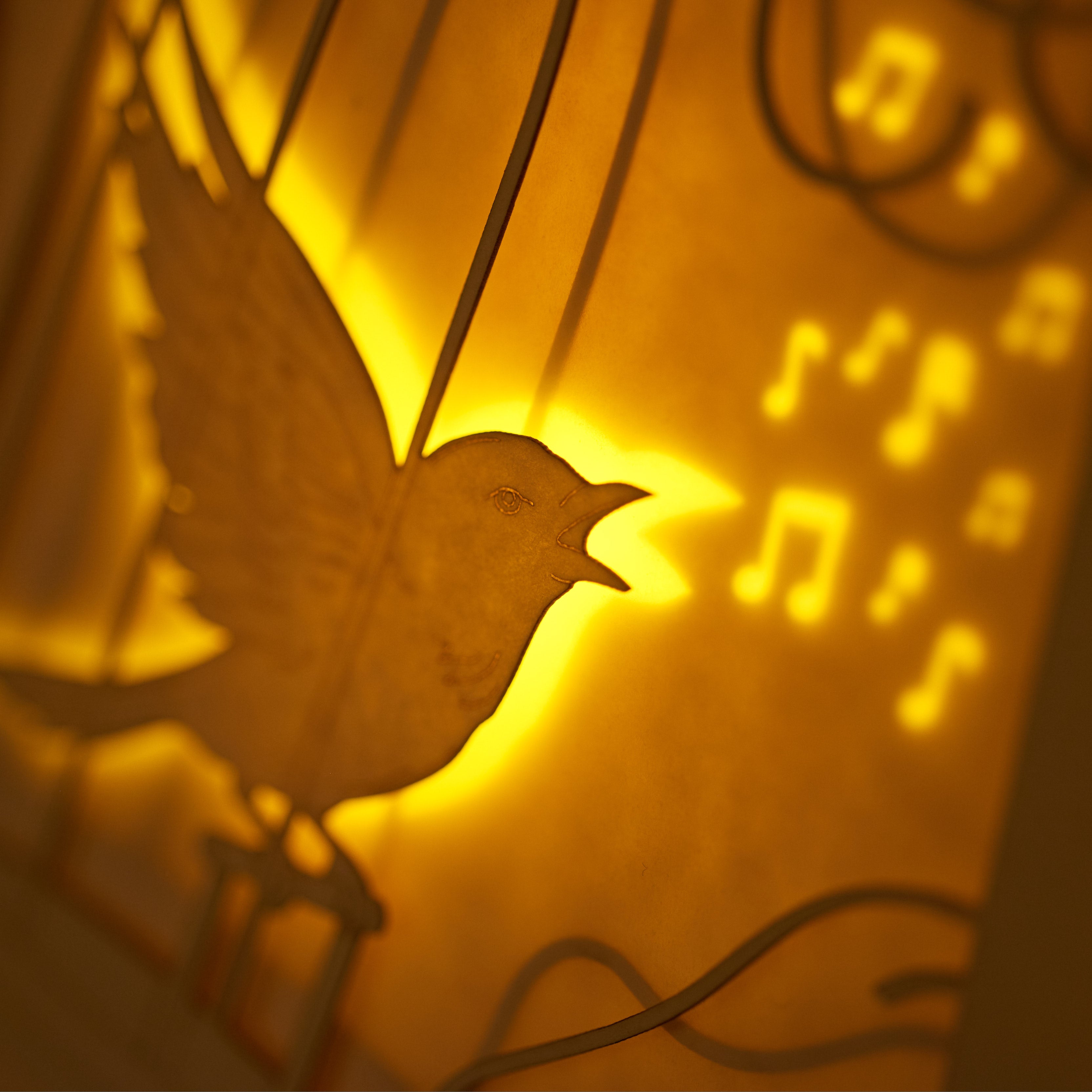 Bird escaping golden cage through song with broken bars