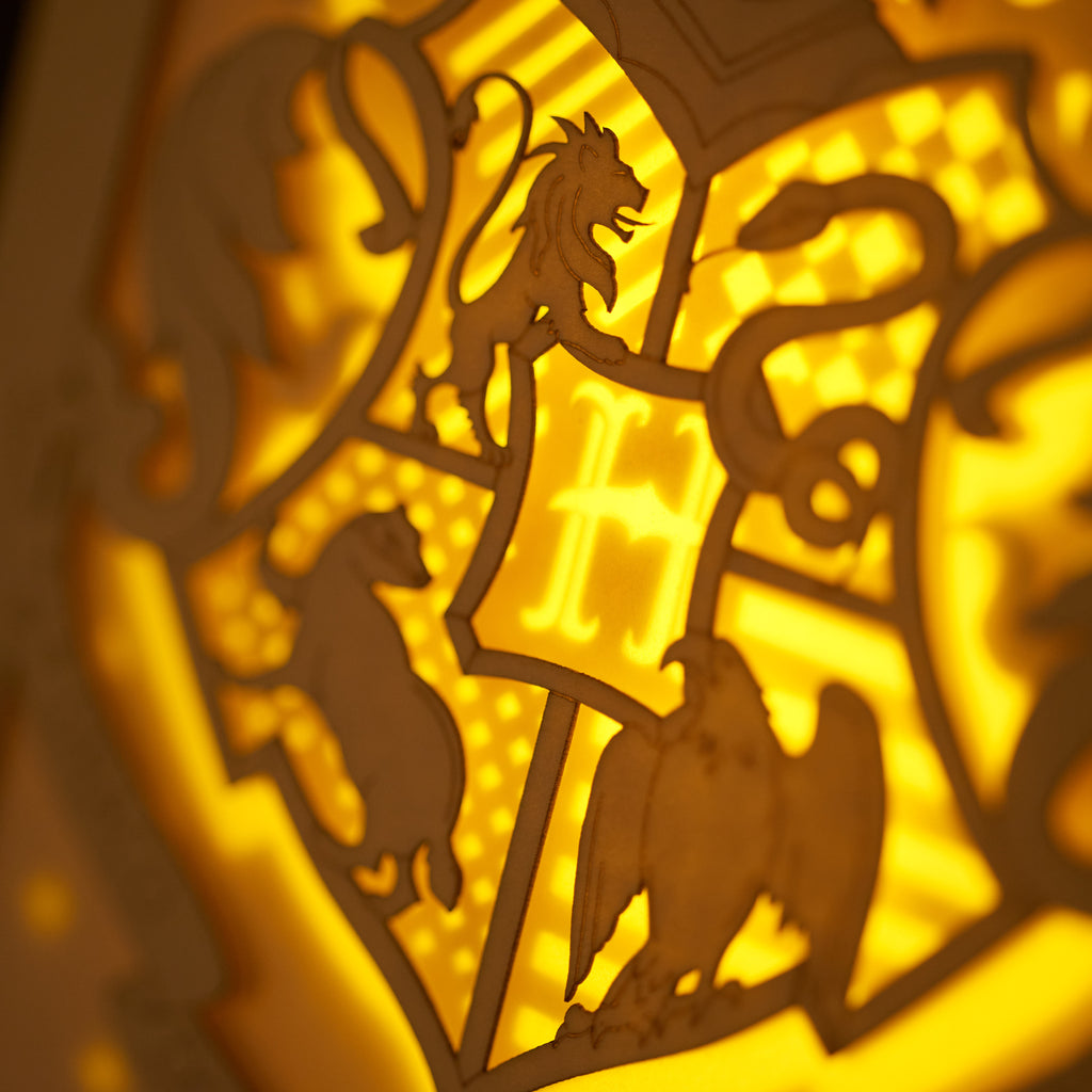 Hogwarts crest with magical details across three layers