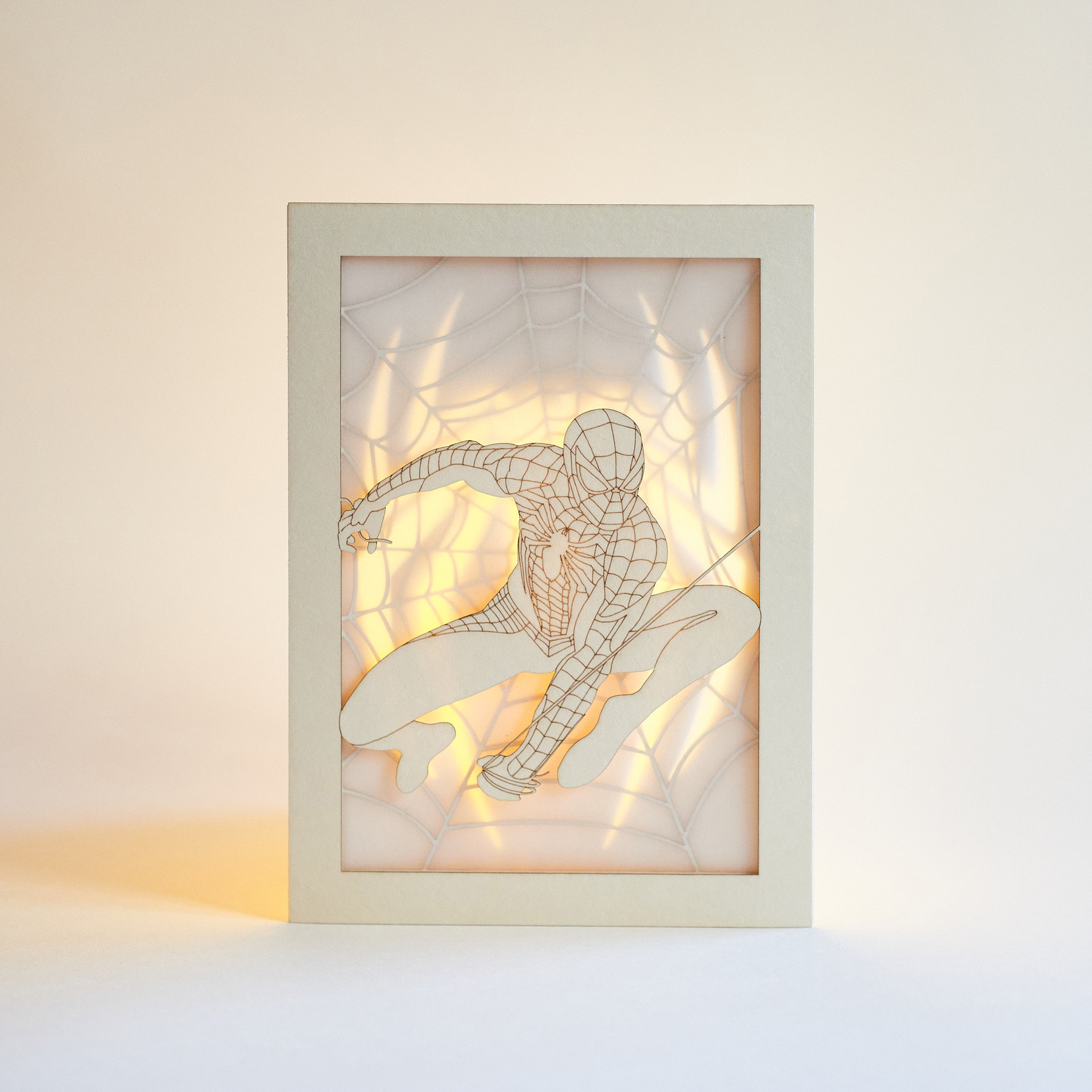 Spider-Man swinging on web with logo and intricate web design