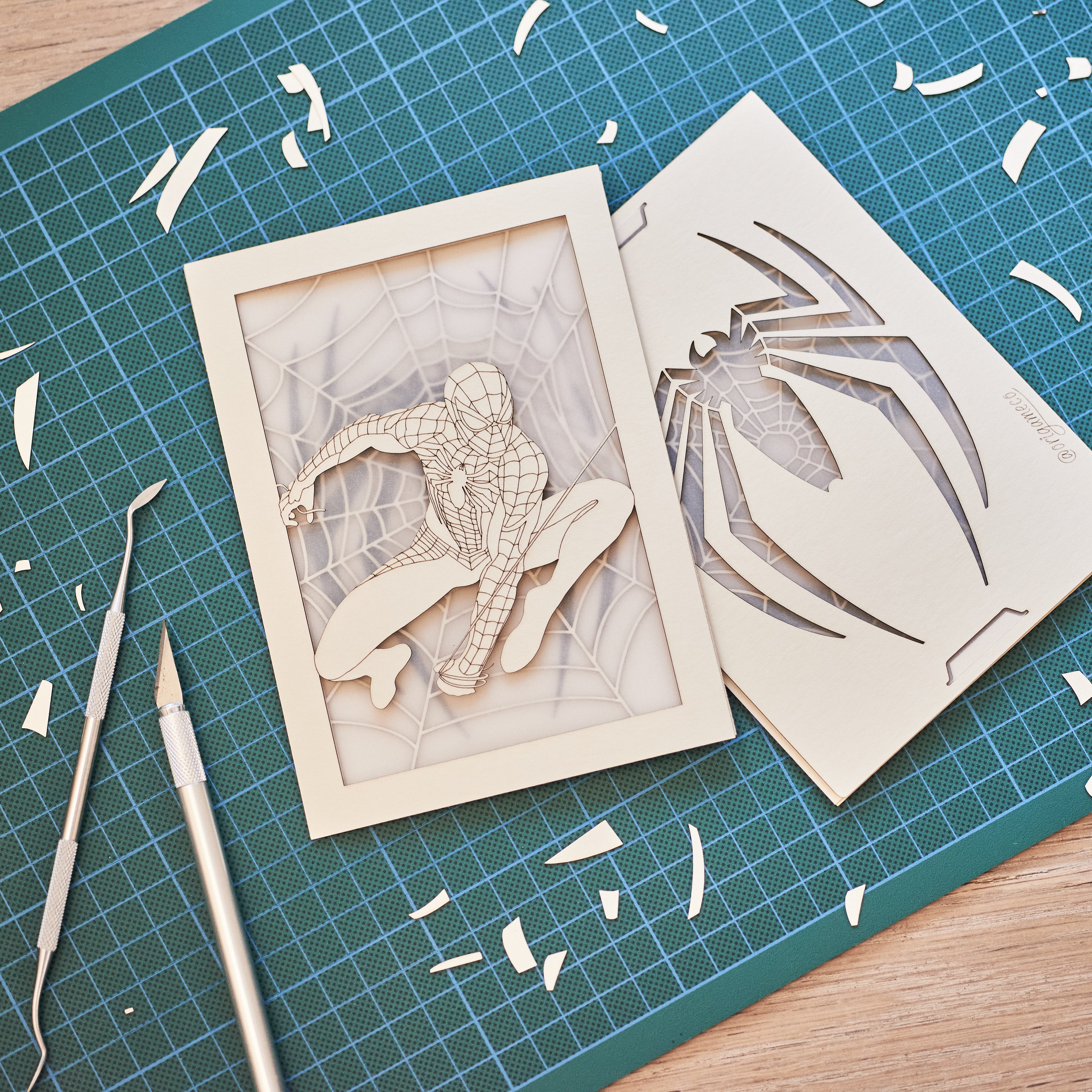 Spider-Man swinging on web with logo and intricate web design