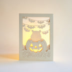 Cute capybara in jack-o-lantern with candy and bats Halloween