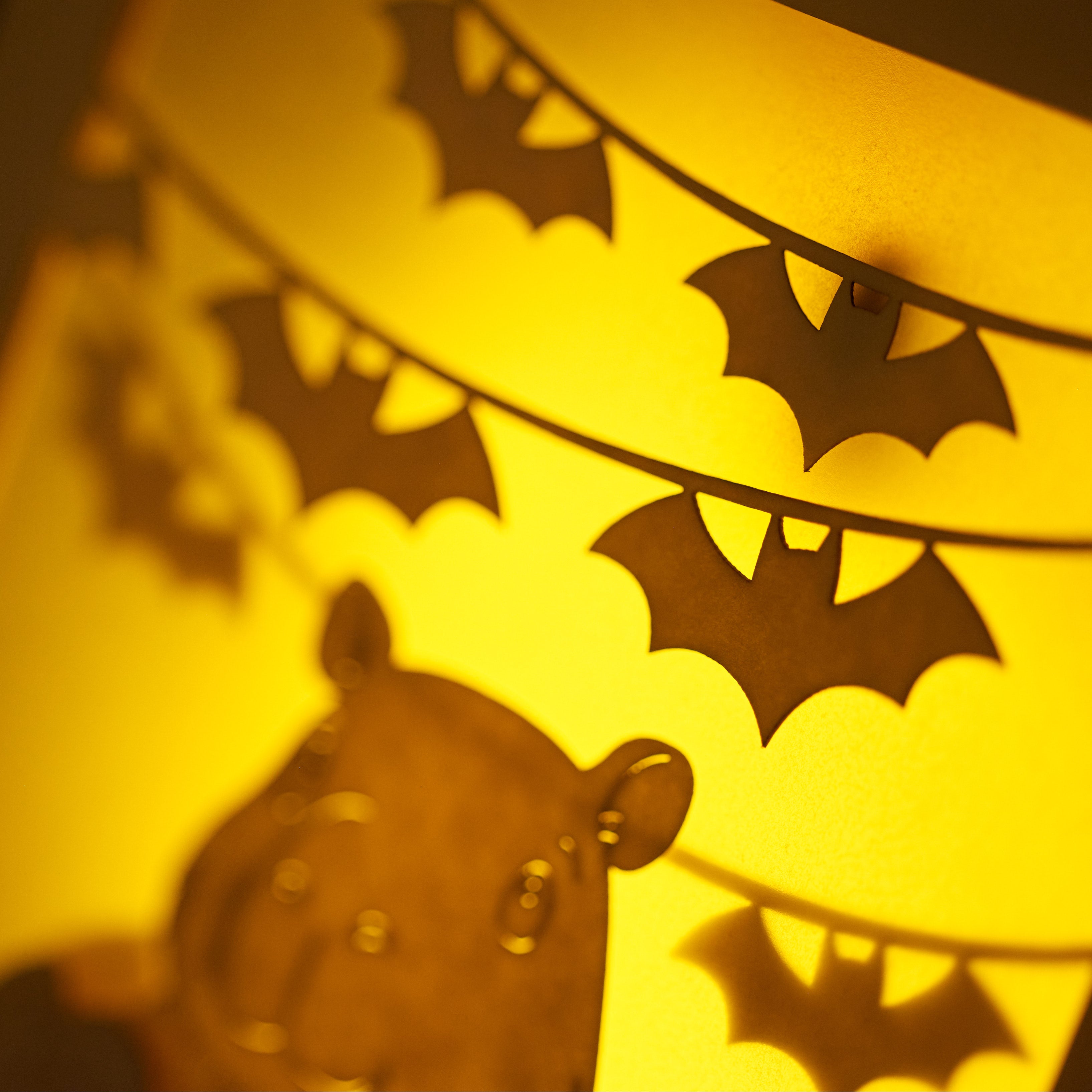 Cute capybara in jack-o-lantern with candy and bats Halloween