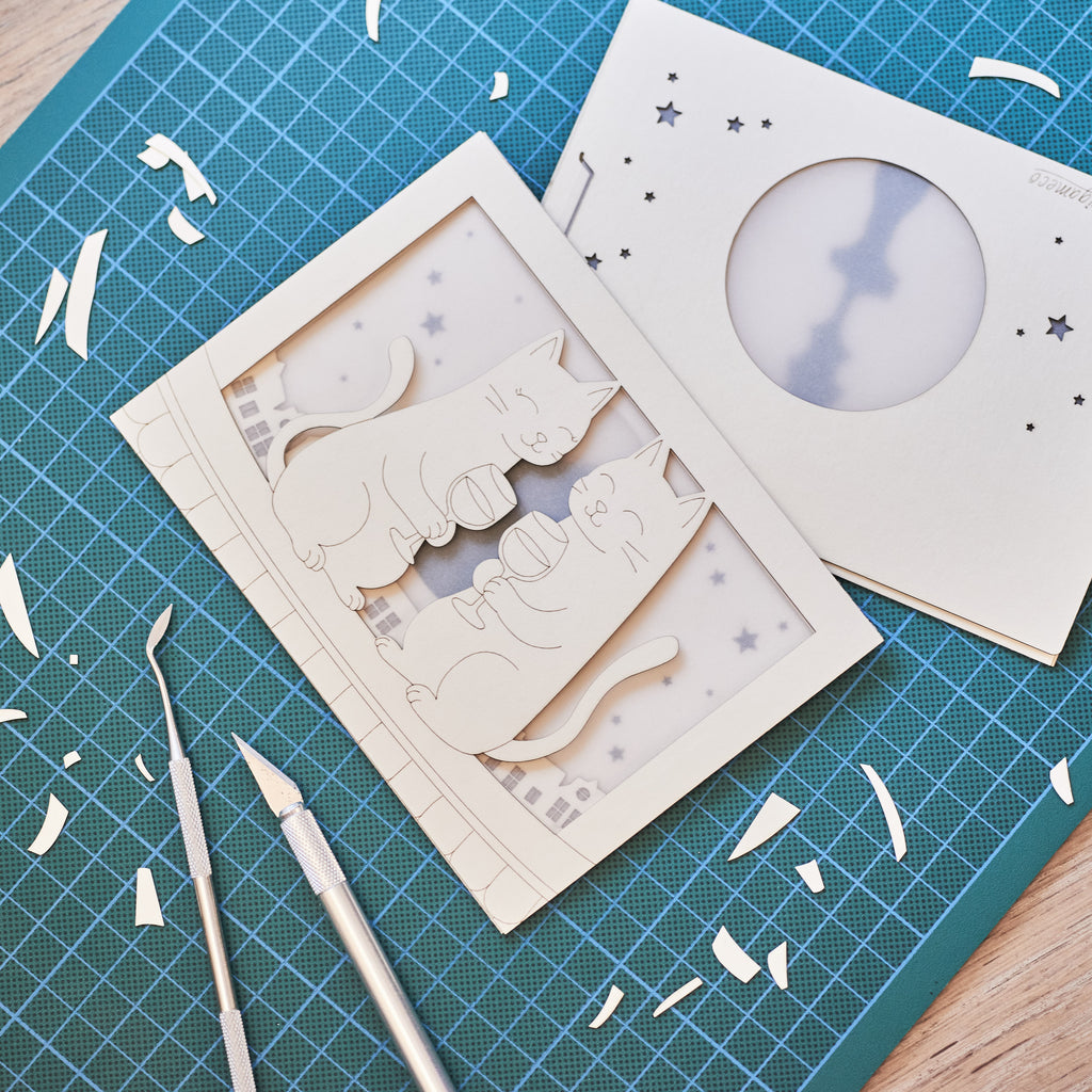 Two cats drinking wine on rooftop under moon with city view
