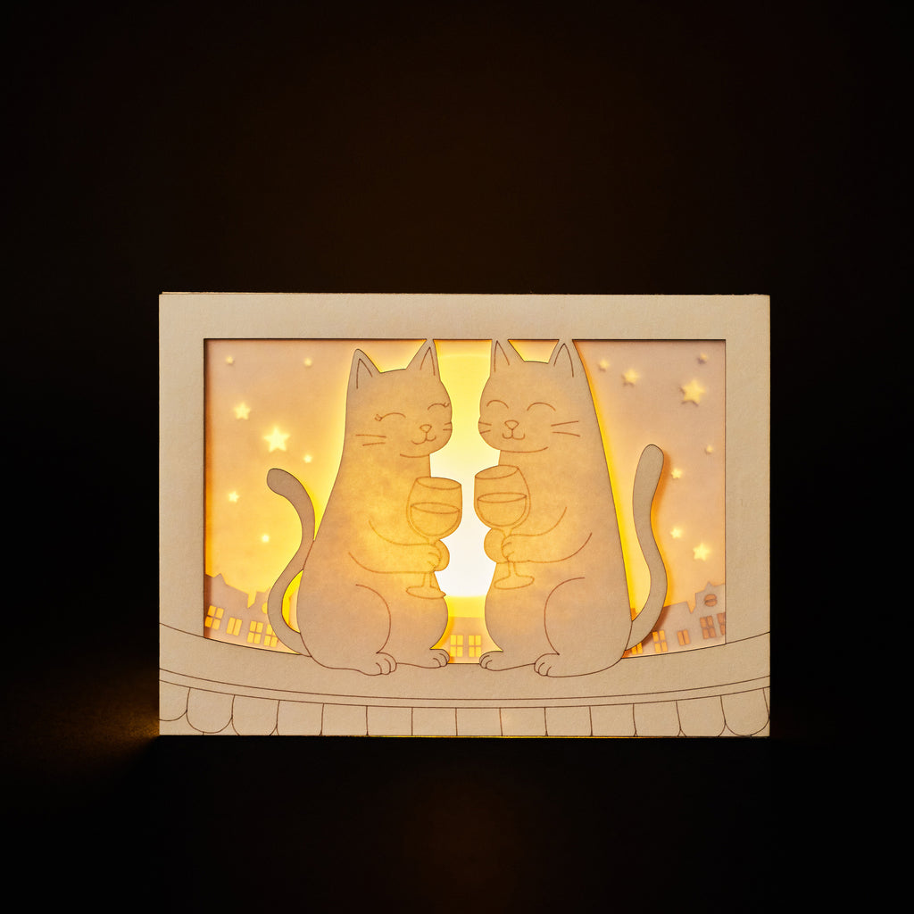 Two cats drinking wine on rooftop under moon with city view