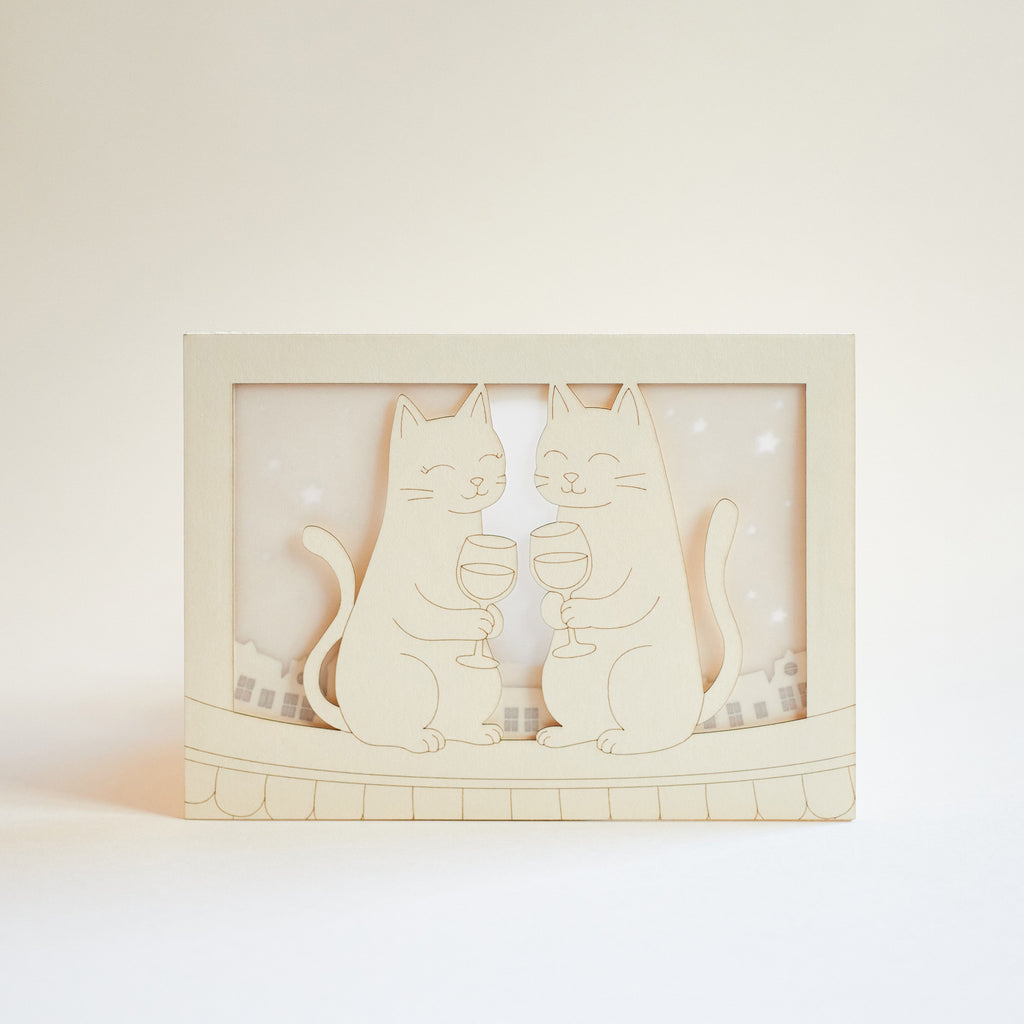 Two cats drinking wine on rooftop under moon with city view