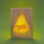 Video of a laser cut shadow box card with a UFO and cow silhouette on a green background