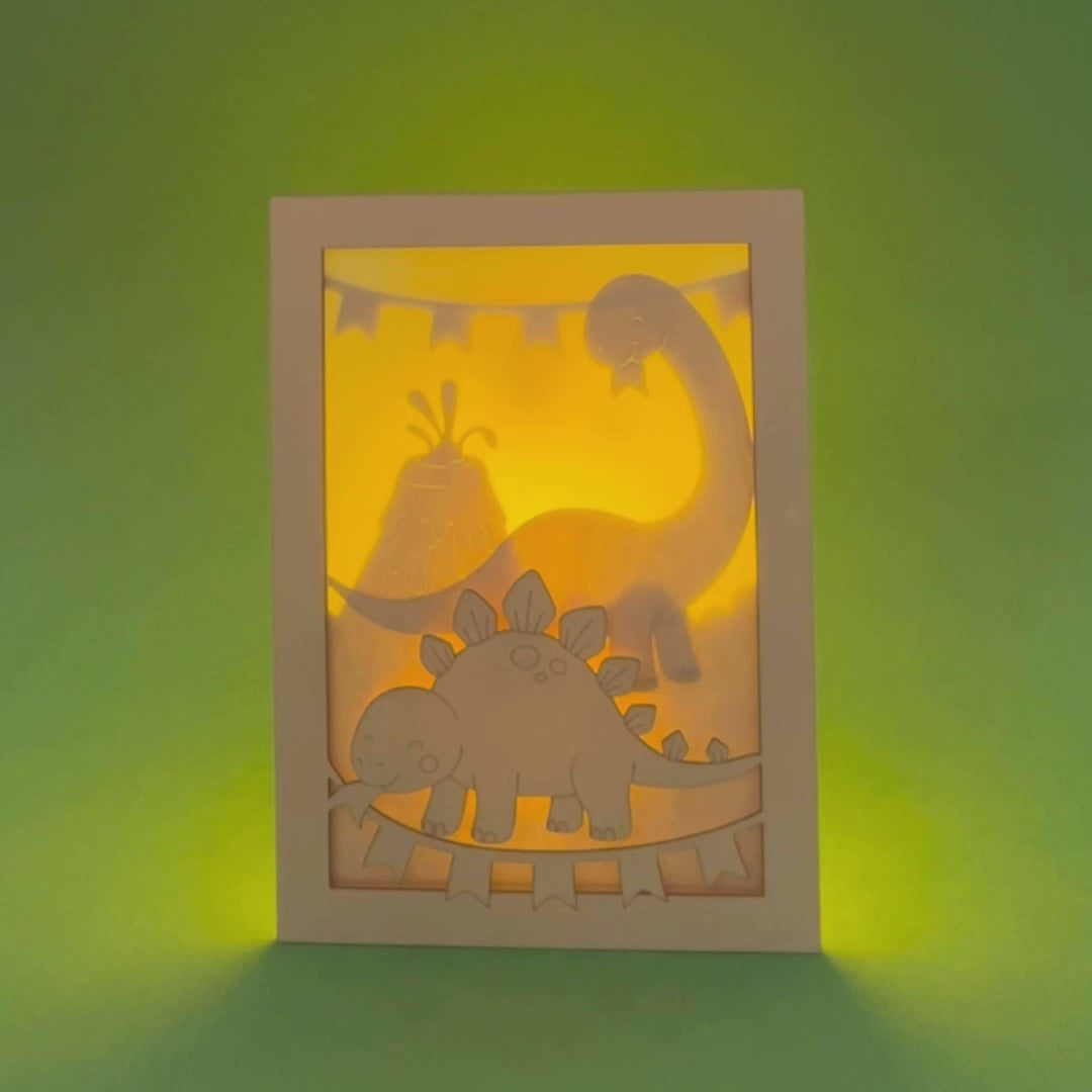 Adorable dinosaurs diplodocus and stegosaurus with birthday streamers and volcano