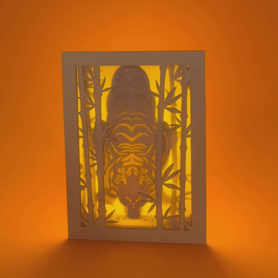 Elegant tiger drinking water among bamboo in forest